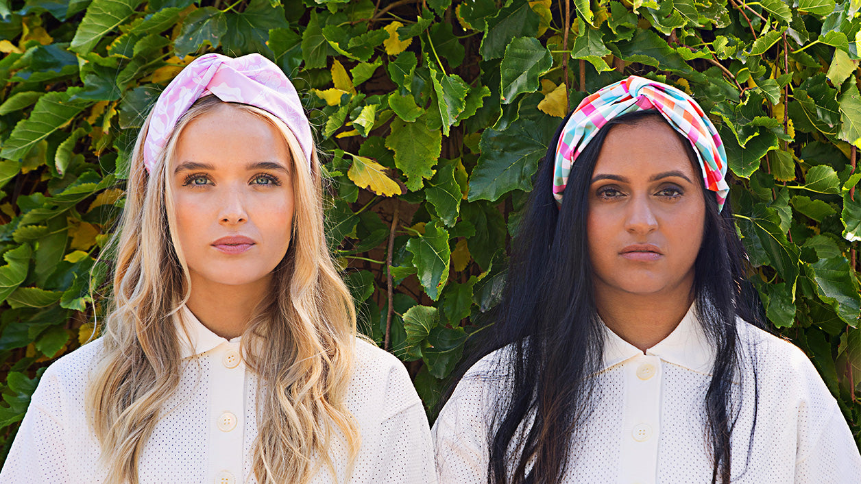 Two_woman_standing_in_garden_wearing_turban_waterproof_headband_english_country_garden_and_ginham_prints