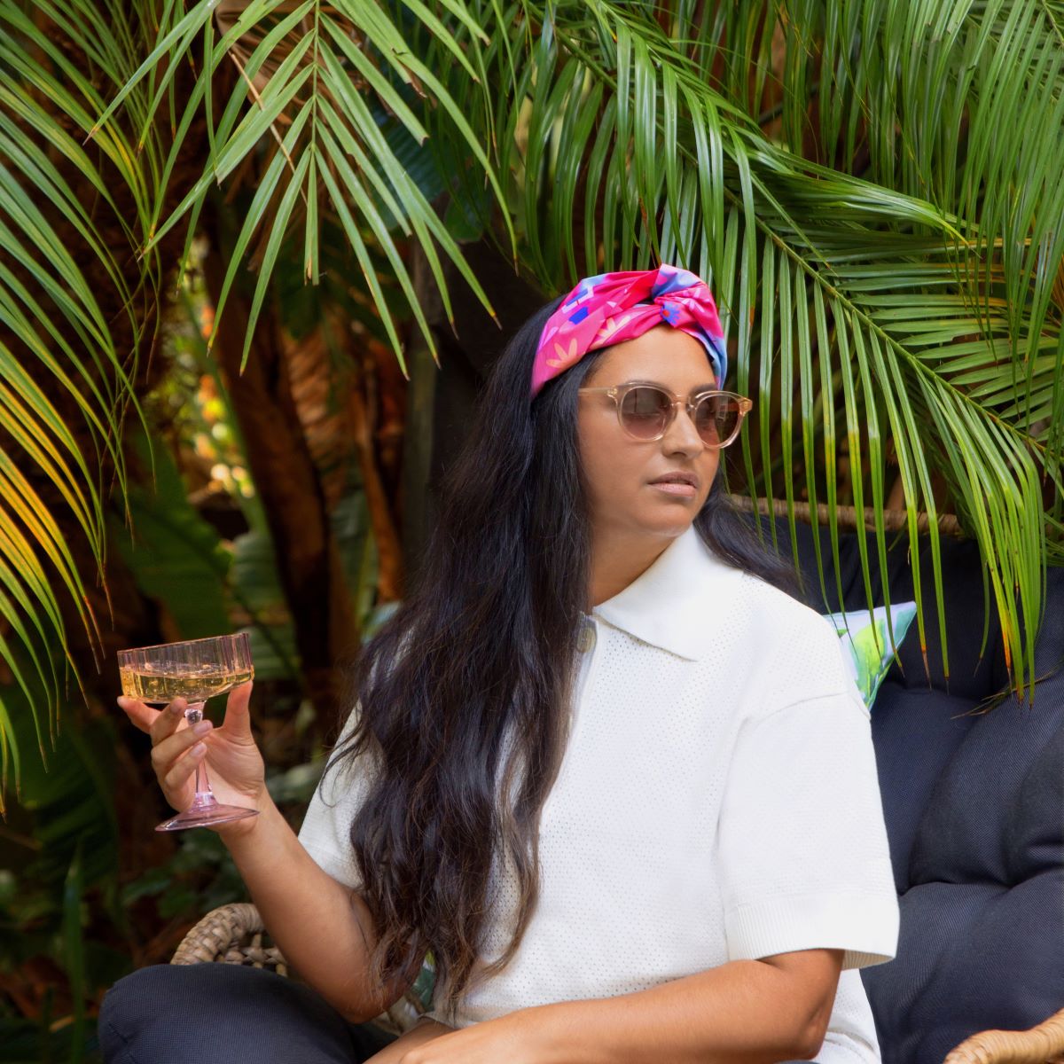 Woman_sitting_in_garden_wearing_turban_waterproof_headband_floral_oil_paiting_print_square